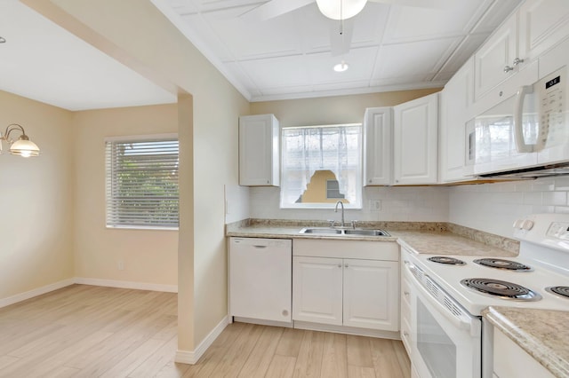 51 Stratford D, West Palm Beach, FL 33417 - kitchen featuring white appliances, a sink, light wood finished floors, and backsplash