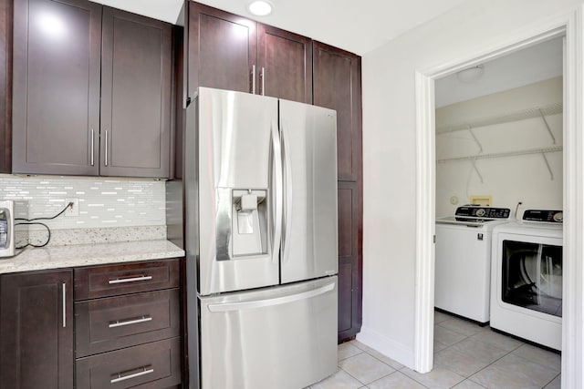 4667 SW 12th Ct, Deerfield Beach, FL 33442 - kitchen with stainless steel refrigerator with ice dispenser, washing machine and clothes dryer, light tile patterned flooring, backsplash, and light stone countertops