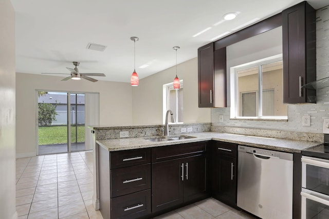 4667 SW 12th Ct, Deerfield Beach, FL 33442 - kitchen with stainless steel appliances, a sink, light tile patterned flooring, a peninsula, and backsplash