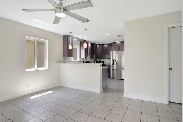 4667 SW 12th Ct, Deerfield Beach, FL 33442 - kitchen with stainless steel refrigerator with ice dispenser, wall chimney range hood, light tile patterned floors, light countertops, and backsplash