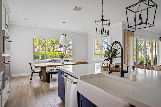 12277 Waterstone Cir, Palm Beach Gardens, FL 33412 - kitchen featuring a sink, blue cabinetry, a chandelier, ornamental molding, and dishwasher