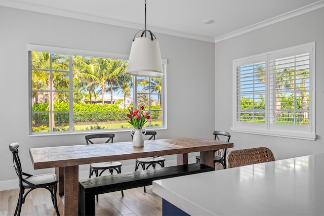 12277 Waterstone Cir, Palm Beach Gardens, FL 33412 - dining area featuring wood finished floors, crown molding, and baseboards