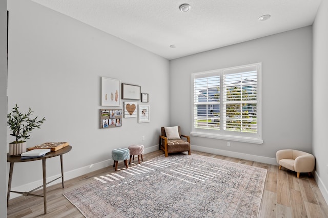 12277 Waterstone Cir, Palm Beach Gardens, FL 33412 - sitting room with baseboards and wood finished floors