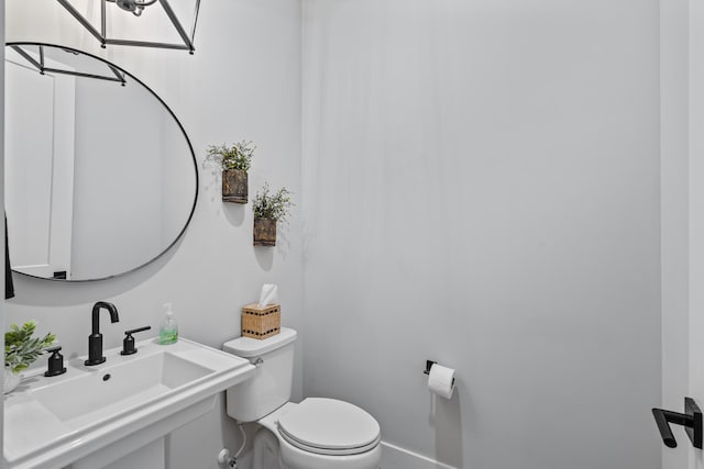 12277 Waterstone Cir, Palm Beach Gardens, FL 33412 - bathroom featuring a sink, toilet, and baseboards