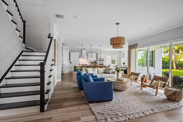 12277 Waterstone Cir, Palm Beach Gardens, FL 33412 - living room featuring ornamental molding, wood finished floors, stairs, recessed lighting, and baseboards