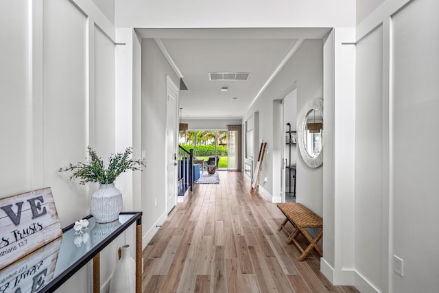 12277 Waterstone Cir, Palm Beach Gardens, FL 33412 - corridor with light wood finished floors, baseboards, and ornamental molding