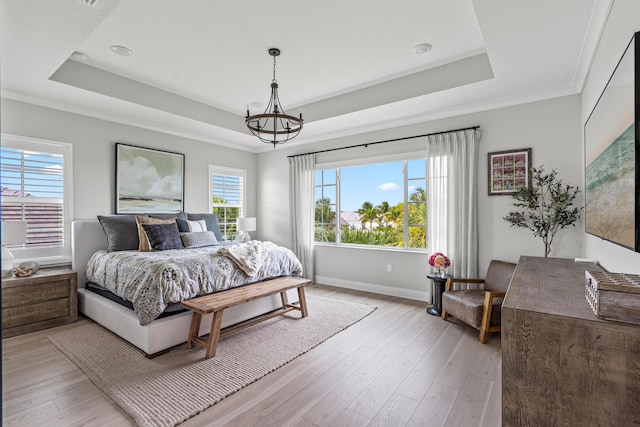 12277 Waterstone Cir, Palm Beach Gardens, FL 33412 - bedroom featuring a tray ceiling, light wood finished floors, baseboards, a chandelier, and ornamental molding
