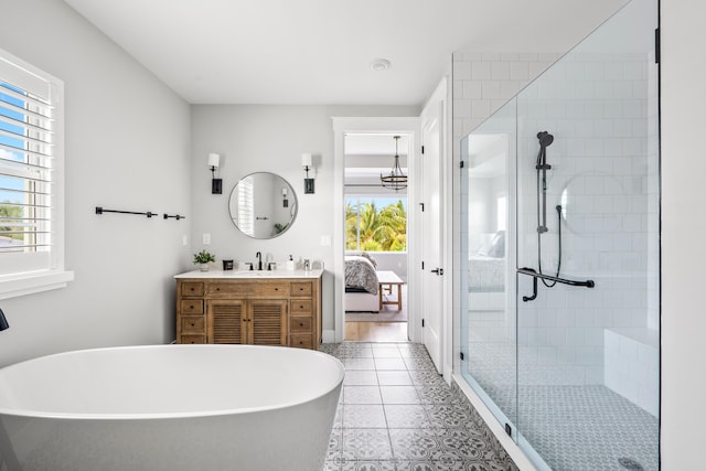 12277 Waterstone Cir, Palm Beach Gardens, FL 33412 - bathroom with a freestanding tub, a stall shower, vanity, tile patterned flooring, and ensuite bath