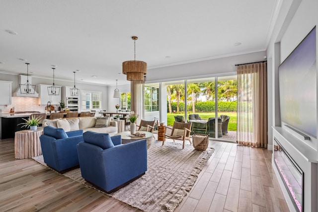 12277 Waterstone Cir, Palm Beach Gardens, FL 33412 - living room featuring light wood-type flooring and ornamental molding