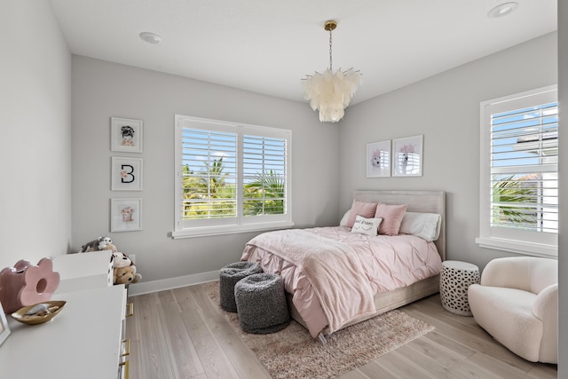12277 Waterstone Cir, Palm Beach Gardens, FL 33412 - bedroom with a chandelier, light wood-style floors, baseboards, and recessed lighting