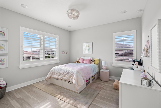 12277 Waterstone Cir, Palm Beach Gardens, FL 33412 - bedroom featuring light wood-type flooring and baseboards