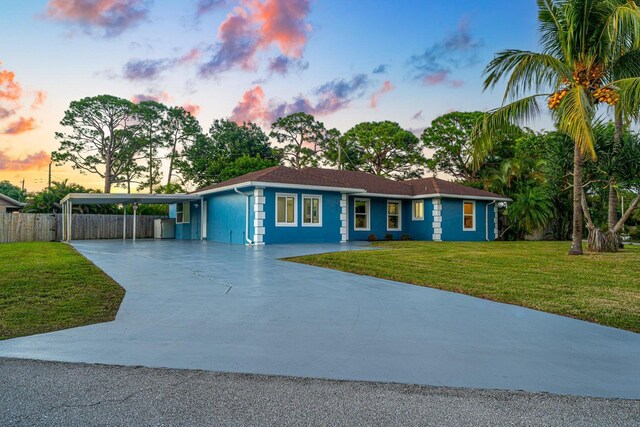 5031 Van Buren Rd, Delray Beach, FL 33484 - ranch-style home with concrete driveway and a carport
