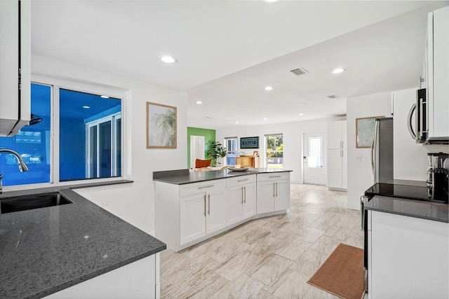 5031 Van Buren Rd, Delray Beach, FL 33484 - kitchen featuring a sink, white cabinets, appliances with stainless steel finishes, light marble finish flooring, and recessed lighting