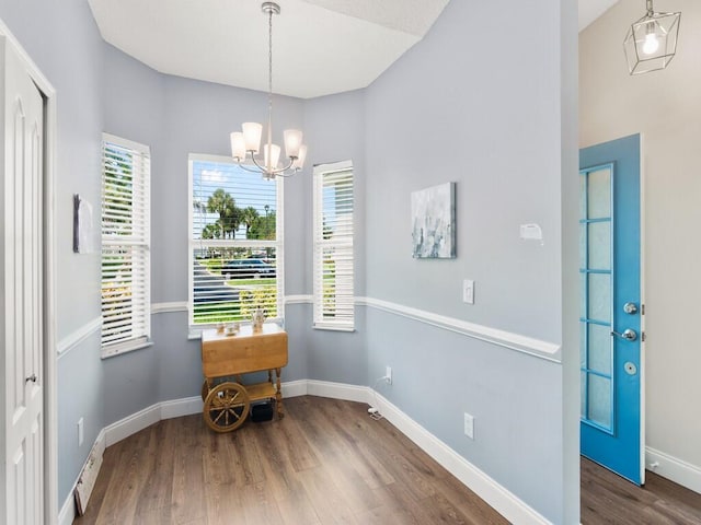 470 NW Gibraltar Ct, Port Saint Lucie, FL 34986 - dining space featuring wood finished floors, a chandelier, and baseboards