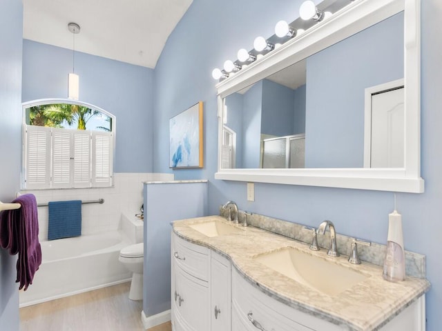 470 NW Gibraltar Ct, Port Saint Lucie, FL 34986 - full bathroom with a bath, double vanity, a stall shower, toilet, and wood finished floors
