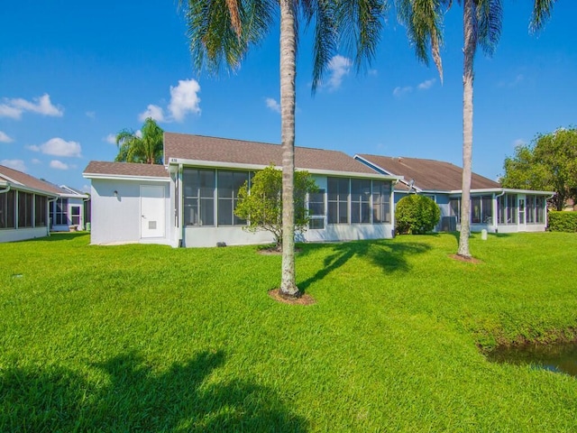 470 NW Gibraltar Ct, Port Saint Lucie, FL 34986 - rear view of house featuring a sunroom and a yard