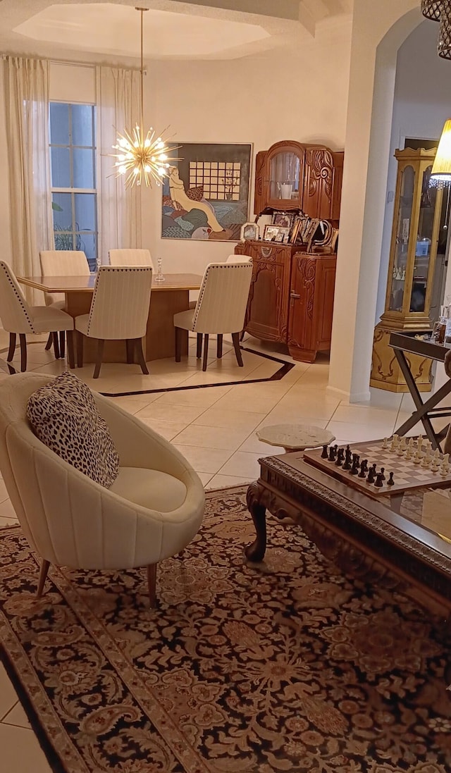 6687 Jog Palm Dr, Boynton Beach, FL 33437 - living room featuring light tile patterned floors, arched walkways, and a chandelier