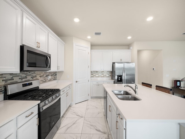 10621 SW Morning Glory Dr, Port Saint Lucie, FL 34987 - kitchen featuring appliances with stainless steel finishes, light marble finish floors, a sink, white cabinetry, and recessed lighting