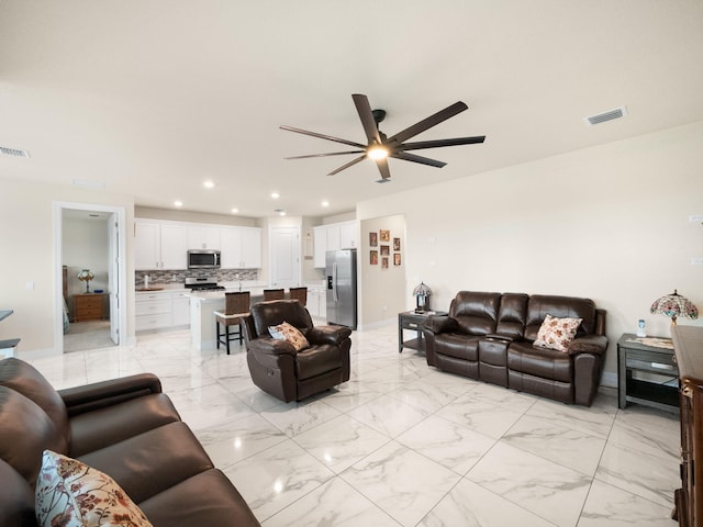 10621 SW Morning Glory Dr, Port Saint Lucie, FL 34987 - living area featuring ceiling fan, recessed lighting, light marble finish flooring, and baseboards