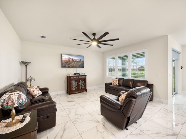 10621 SW Morning Glory Dr, Port Saint Lucie, FL 34987 - living room featuring light marble finish flooring, ceiling fan, and baseboards