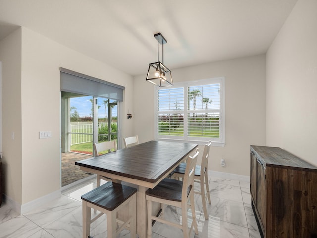 10621 SW Morning Glory Dr, Port Saint Lucie, FL 34987 - dining area featuring light marble finish flooring and baseboards