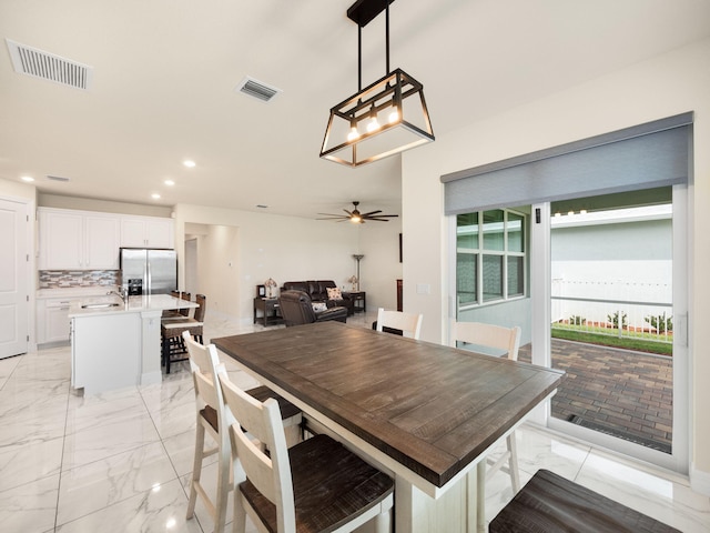 10621 SW Morning Glory Dr, Port Saint Lucie, FL 34987 - dining room with light marble finish floors, a ceiling fan, and recessed lighting