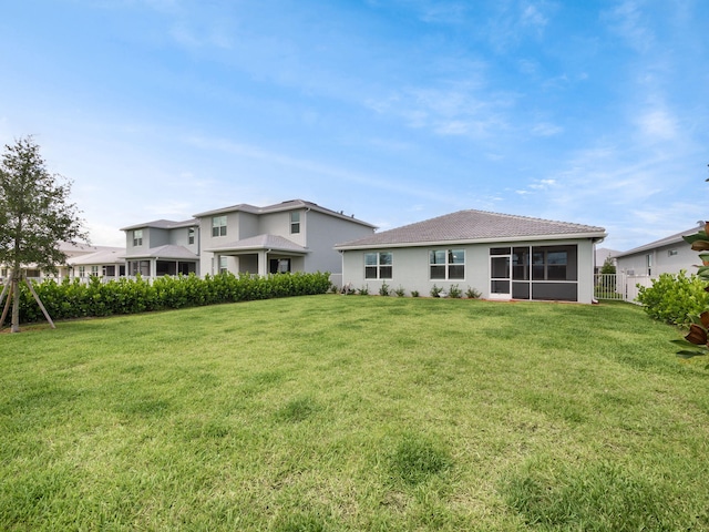 10621 SW Morning Glory Dr, Port Saint Lucie, FL 34987 - back of property featuring a sunroom, stucco siding, and a tile roof