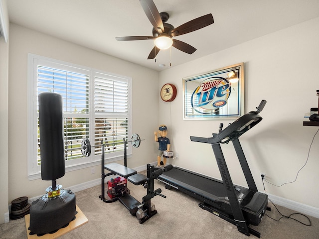 10621 SW Morning Glory Dr, Port Saint Lucie, FL 34987 - exercise room featuring a ceiling fan, baseboards, and carpet