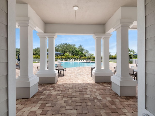 10621 SW Morning Glory Dr, Port Saint Lucie, FL 34987 - view of patio with a community pool