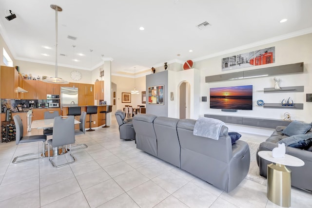 7181 Veneto Dr, Boynton Beach, FL 33437 - living area with light tile patterned flooring, crown molding, arched walkways, recessed lighting, and a chandelier