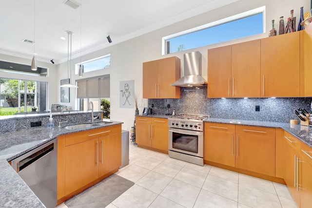 7181 Veneto Dr, Boynton Beach, FL 33437 - kitchen featuring stainless steel appliances, wall chimney exhaust hood, a sink, dark stone countertops, and ornamental molding