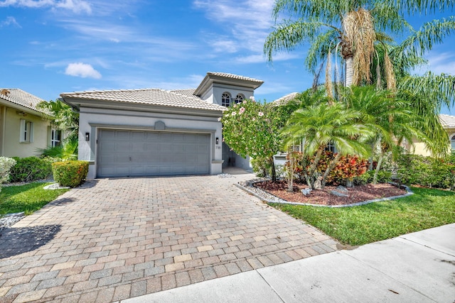7181 Veneto Dr, Boynton Beach, FL 33437 - mediterranean / spanish-style house with a tiled roof, stucco siding, decorative driveway, and a garage