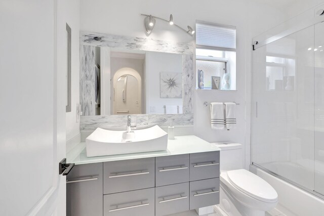 7181 Veneto Dr, Boynton Beach, FL 33437 - bathroom with vanity, combined bath / shower with glass door, and toilet