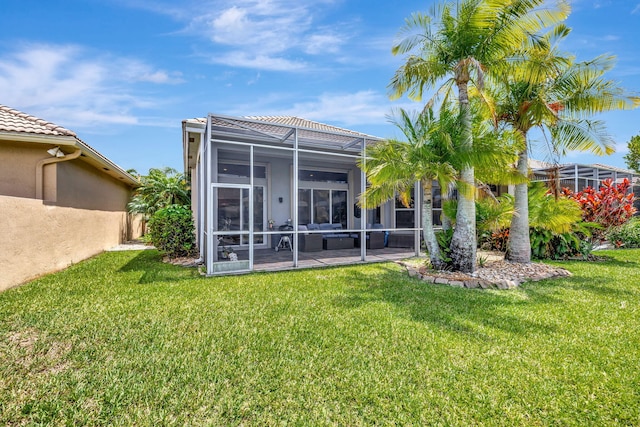 7181 Veneto Dr, Boynton Beach, FL 33437 - back of house with stucco siding, a lawn, and glass enclosure