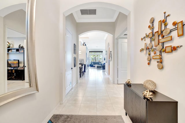 7181 Veneto Dr, Boynton Beach, FL 33437 - hall featuring light tile patterned floors, arched walkways, and baseboards
