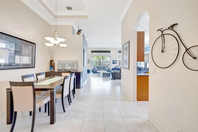 7181 Veneto Dr, Boynton Beach, FL 33437 - dining area with a chandelier, arched walkways, light tile patterned floors, baseboards, and ornamental molding