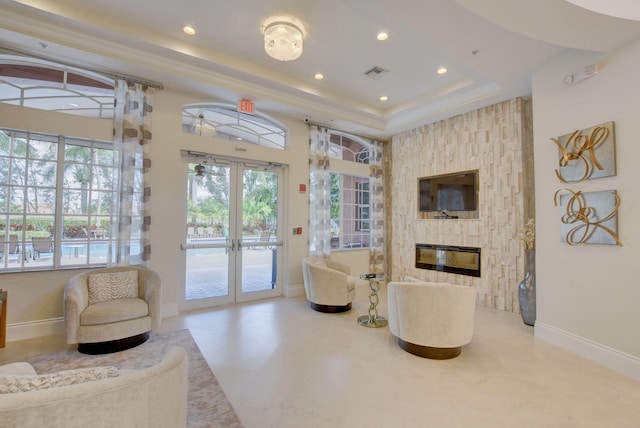 7181 Veneto Dr, Boynton Beach, FL 33437 - living area featuring a raised ceiling, recessed lighting, baseboards, a fireplace, and french doors