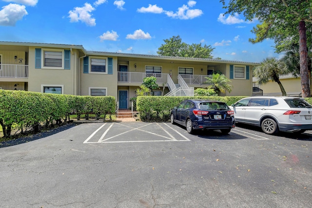 18 Westgate Ln Unit 18F, Boynton Beach, FL 33436 - view of property with uncovered parking and stairs