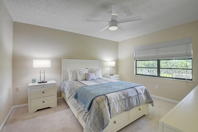 18 Westgate Ln Unit 18F, Boynton Beach, FL 33436 - bedroom with light colored carpet, a textured ceiling, baseboards, and a ceiling fan