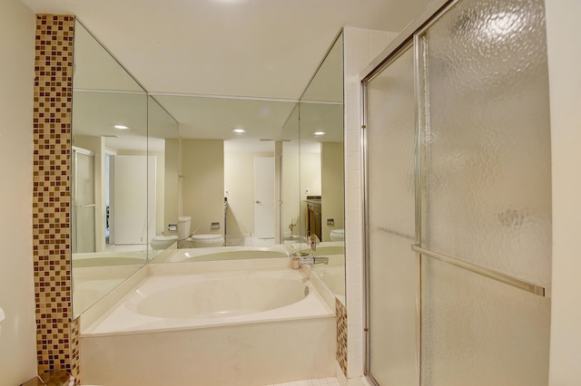 18 Westgate Ln Unit 18F, Boynton Beach, FL 33436 - bathroom featuring recessed lighting, a garden tub, a shower stall, and toilet
