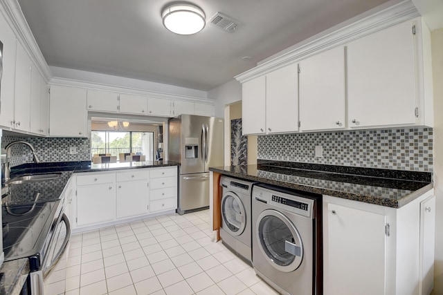 18 Westgate Ln Unit 18F, Boynton Beach, FL 33436 - kitchen with stainless steel fridge with ice dispenser, washing machine and clothes dryer, a sink, electric stove, and light tile patterned floors