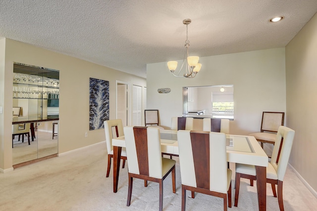 18 Westgate Ln Unit 18F, Boynton Beach, FL 33436 - dining space featuring a chandelier, light carpet, a textured ceiling, and baseboards