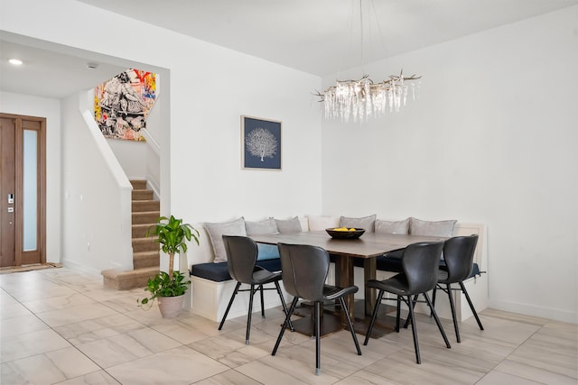 7102 Rockwood Rd, Jupiter, FL 33458 - dining space with a chandelier, stairway, baseboards, and marble look tile flooring