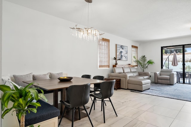 7102 Rockwood Rd, Jupiter, FL 33458 - dining area featuring a chandelier and light marble finish flooring