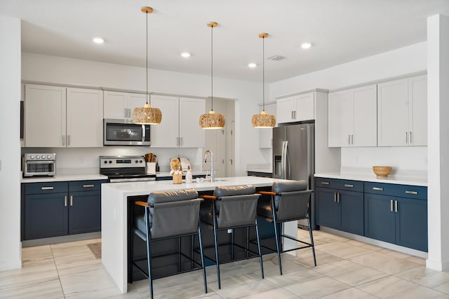 7102 Rockwood Rd, Jupiter, FL 33458 - kitchen featuring appliances with stainless steel finishes, a sink, a breakfast bar, light marble finish flooring, and light countertops