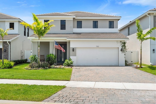 7102 Rockwood Rd, Jupiter, FL 33458 - view of front of home featuring an attached garage, stucco siding, decorative driveway, and a tiled roof