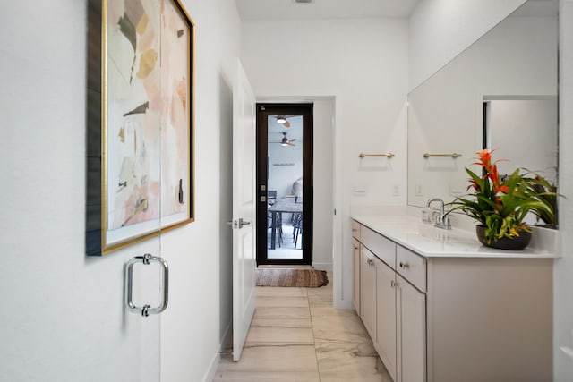 7102 Rockwood Rd, Jupiter, FL 33458 - full bathroom featuring vanity, marble look tiles, and baseboards