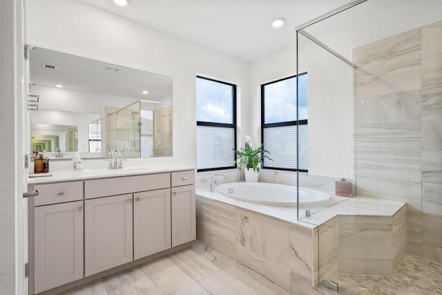 7102 Rockwood Rd, Jupiter, FL 33458 - full bath with healthy amount of natural light, a stall shower, vanity, a bath, and recessed lighting