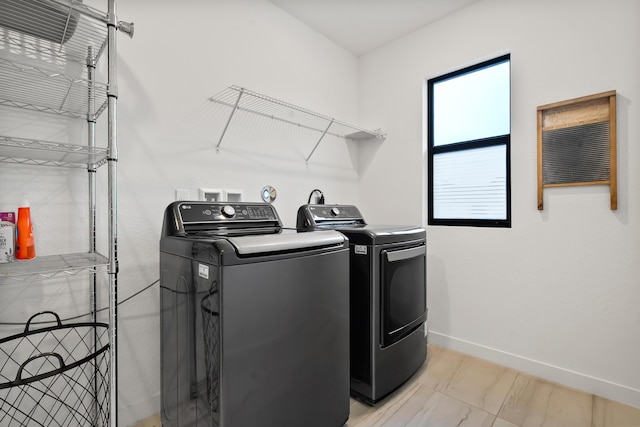 7102 Rockwood Rd, Jupiter, FL 33458 - laundry room featuring independent washer and dryer, baseboards, and light marble finish floors