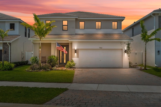 7102 Rockwood Rd, Jupiter, FL 33458 - view of front of house with decorative driveway, stucco siding, and a garage